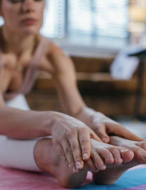 Close-up view of a person's feet on a yoga mat.